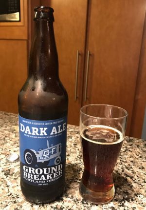 Glass and bottle of Ground Breaker Dark Ale gluten free beer